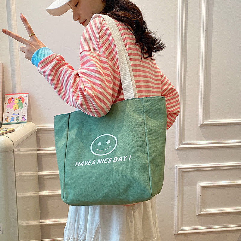 လက်ကား Smiley Face Tote Bag ကြီးမားသောစွမ်းရည်အိတ် အမျိုးသမီးများ 2023 စွယ်စုံရပခုံးအိတ် ကျောင်းသား ကျူတိုရီရယ်အိတ်အသစ် 