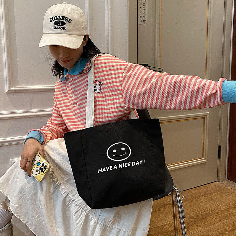 လက်ကား Smiley Face Tote Bag ကြီးမားသောစွမ်းရည်အိတ် အမျိုးသမီးများ 2023 စွယ်စုံရပခုံးအိတ် ကျောင်းသား ကျူတိုရီရယ်အိတ်အသစ် 