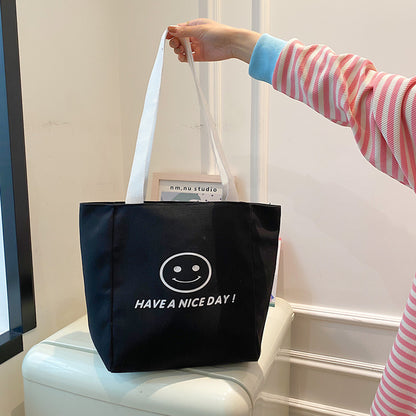 လက်ကား Smiley Face Tote Bag ကြီးမားသောစွမ်းရည်အိတ် အမျိုးသမီးများ 2023 စွယ်စုံရပခုံးအိတ် ကျောင်းသား ကျူတိုရီရယ်အိတ်အသစ် 