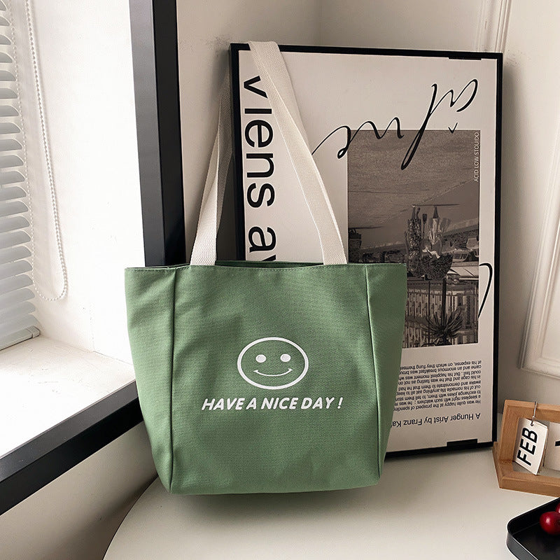 လက်ကား Smiley Face Tote Bag ကြီးမားသောစွမ်းရည်အိတ် အမျိုးသမီးများ 2023 စွယ်စုံရပခုံးအိတ် ကျောင်းသား ကျူတိုရီရယ်အိတ်အသစ် 