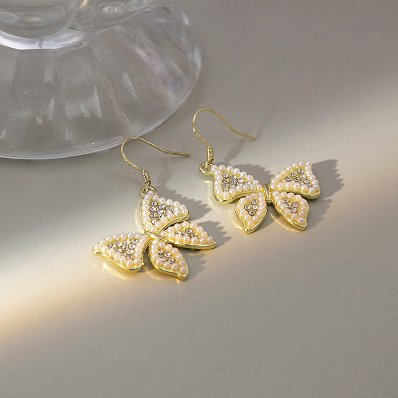 Japanese and Korean diamond-encrusted geometric earrings niche light luxury high-end pearl oil dripping bow earrings wholesale 