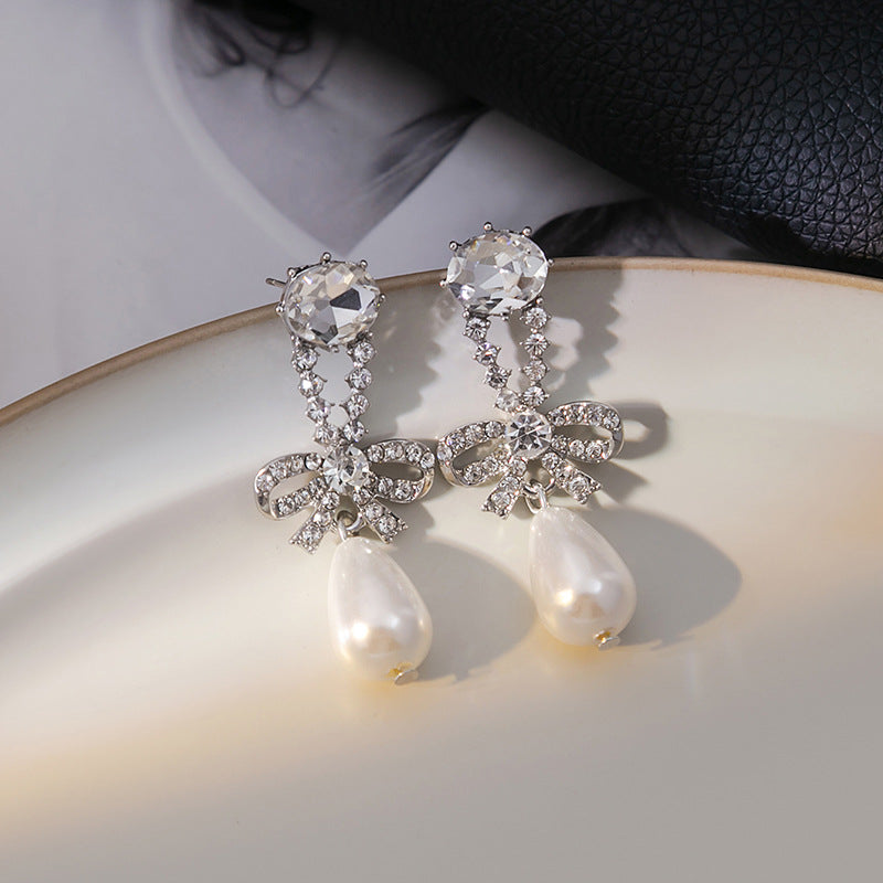 Japanese and Korean diamond-encrusted geometric earrings niche light luxury high-end pearl oil dripping bow earrings wholesale 