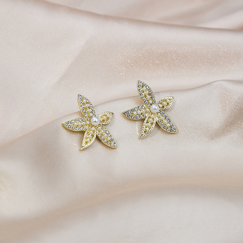 Japanese and Korean diamond-encrusted geometric earrings niche light luxury high-end pearl oil dripping bow earrings wholesale 