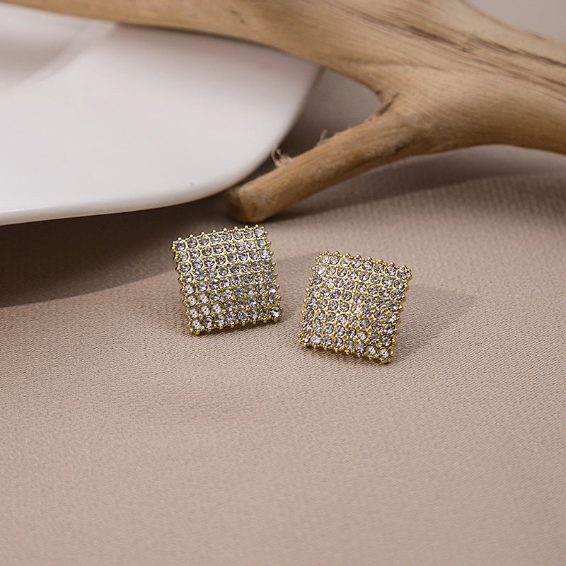 Japanese and Korean diamond-encrusted geometric earrings niche light luxury high-end pearl oil dripping bow earrings wholesale 